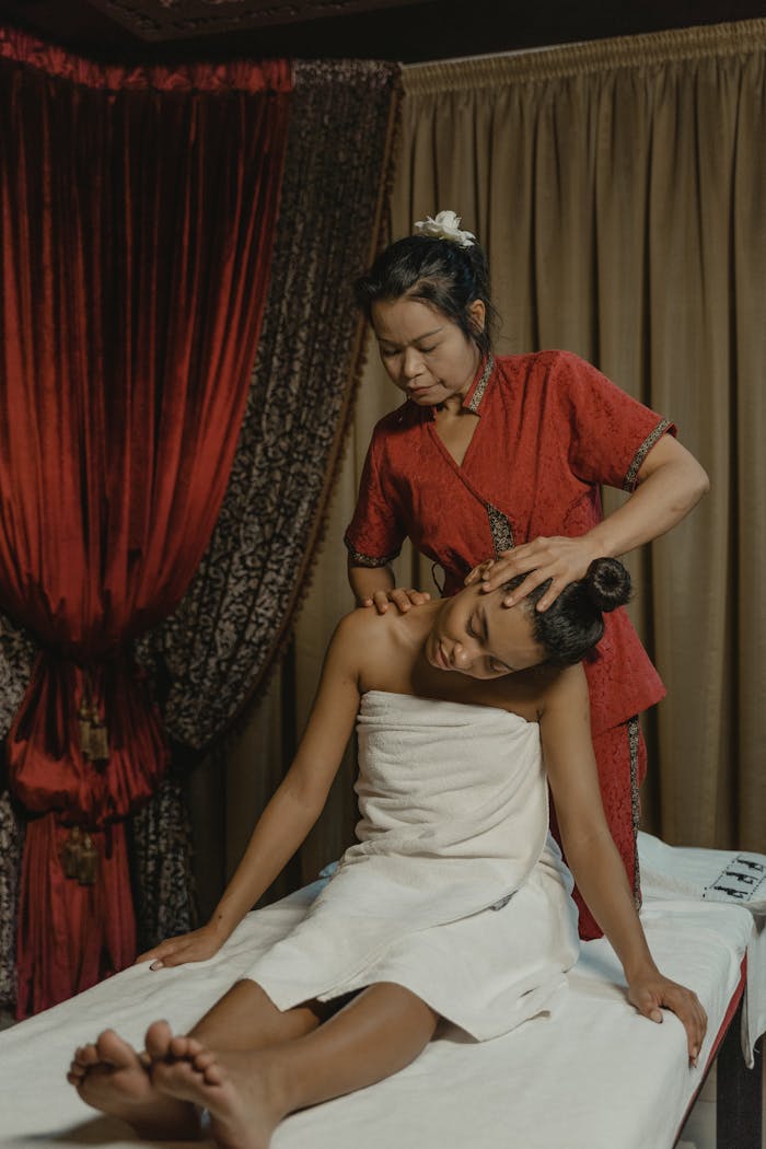 A serene massage therapy session featuring two women for ultimate relaxation.