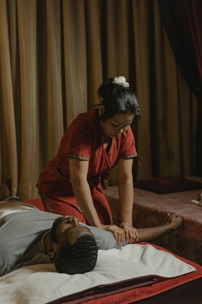 A relaxing massage therapy session in a serene spa setting with professional masseur.